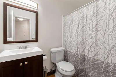 a bathroom with a toilet and a sink and a mirror at Urban Oasis Near Old Town & PVH - Dog Friendly! in Fort Collins