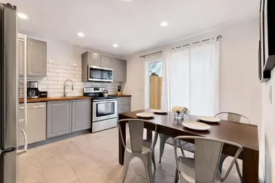 a kitchen with a wooden table and chairs in it at Comfortable Abode Near Historic Downtown in Loveland