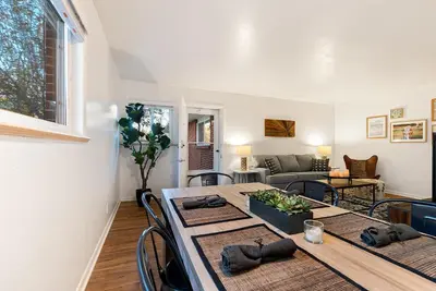a living room with a table and a couch at Couples Getaway - Dog Friendly, Bike to Old Town! in Fort Collins