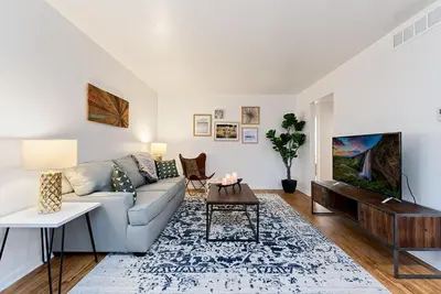 a living room with a couch and a table at Couples Getaway - Dog Friendly, Bike to Old Town! in Fort Collins