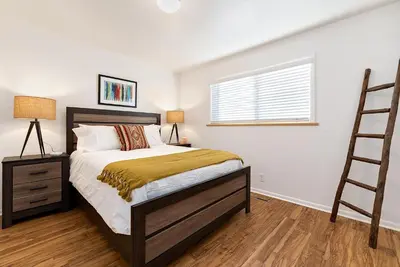 a bedroom with a bed and a ladder in it at Couples Getaway - Dog Friendly, Bike to Old Town! in Fort Collins