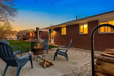 a patio with two chairs and a fire pit at Couples Getaway - Dog Friendly, Bike to Old Town! in Fort Collins