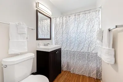 a bathroom with a sink and a shower curtain at Ultimate Chill Zone, BBQ, Bikes, Pet Friendly!! in Fort Collins