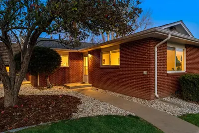 a brick house with a tree in front of it at Ultimate Chill Zone, BBQ, Bikes, Pet Friendly!! in Fort Collins