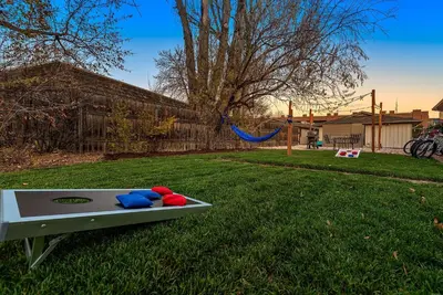 a ping pong table in a yard with a playground at Hidden Gem Near Old Town - Grill & Cruiser Bikes! in Fort Collins
