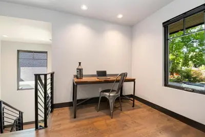 a home office with a desk with a laptop on it at Relaxing in Paradise with Private Rooftop Deck! in Fort Collins