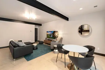 a living room with a table and chairs at Relaxing in Paradise with Private Rooftop Deck! in Fort Collins