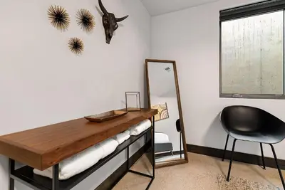 a room with a mirror and a desk and a chair at Relaxing in Paradise with Private Rooftop Deck! in Fort Collins