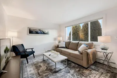 a living room with a couch and a table at Comfortable Home - Close to Rocky Mtn National Park in Loveland