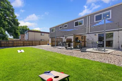 a house with a backyard with a lawn and a table at Comfortable Home - Close to Rocky Mtn National Park in Loveland
