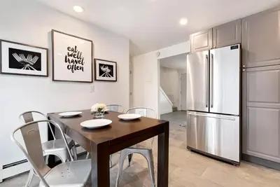 a kitchen with a dining table and a refrigerator at Comfortable Home - Close to Rocky Mtn National Park in Loveland