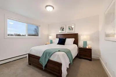 a bedroom with a large bed and a window at Comfortable Home - Close to Rocky Mtn National Park in Loveland