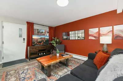 a living room with a couch and a table at Modern & Chic Condo in the Heart of Old Town in Fort Collins