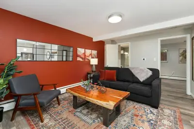 a living room with a couch and a table at Modern & Chic Condo in the Heart of Old Town in Fort Collins