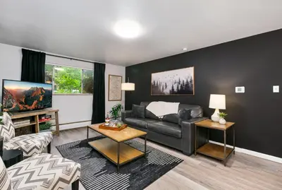 a living room with a couch and a table at Contemporary condo in the heart of Old Town in Fort Collins