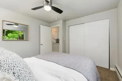 a bedroom with a bed and a ceiling fan at Contemporary condo in the heart of Old Town in Fort Collins