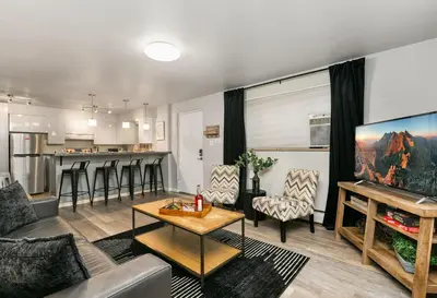 a living room with a couch and a table at Contemporary condo in the heart of Old Town in Fort Collins