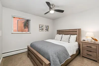 a bedroom with a bed and a ceiling fan at Contemporary condo in the heart of Old Town in Fort Collins
