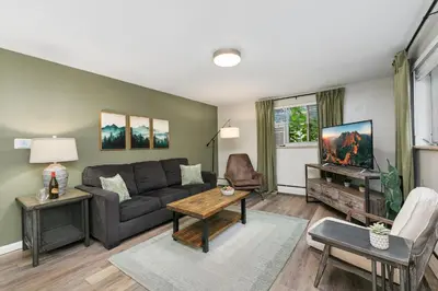a living room with a couch and a table at Stunning Downtown Condo - 5 min walk to Old Town! in Fort Collins