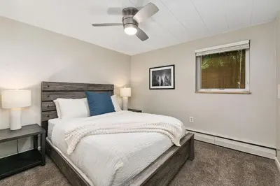 a bedroom with a large bed and a window at Stunning Downtown Condo - 5 min walk to Old Town! in Fort Collins