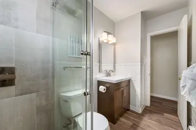 a bathroom with a toilet and a sink and a shower at Stylish Condo in the Heart of Old Town in Fort Collins