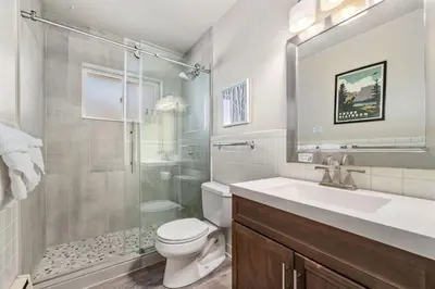 a bathroom with a shower and a toilet and a sink at Stylish Condo in the Heart of Old Town in Fort Collins