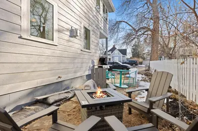 a fire pit outside of a house with two chairs at Newly Renovated in the Heart of Historic Loveland in Loveland