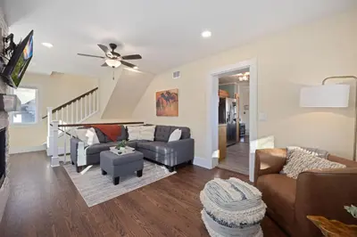 a living room with couches and a ceiling fan at Newly Renovated in the Heart of Historic Loveland in Loveland