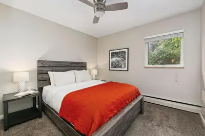 a bedroom with a bed and a window at Old Town Condo by Library Park Walk Everywhere! in Fort Collins