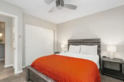 a bedroom with a large bed and a ceiling fan at Old Town Condo by Library Park Walk Everywhere! in Fort Collins