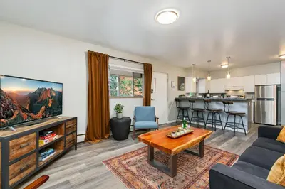 a living room with a couch and a table at Gorgeous Condo in the Heart of Old Town in Fort Collins