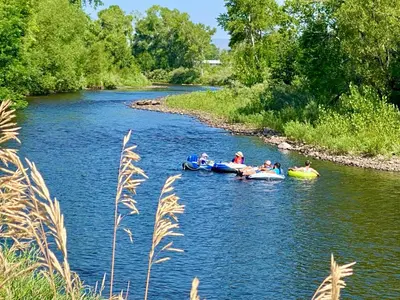 a group of people riding on tubes down a river at Gorgeous Condo in the Heart of Old Town in Fort Collins