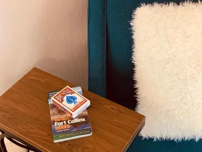 a book sitting on top of a table next to a rug at The Cottage! Chic Bungalow near Old Town Square! in Fort Collins