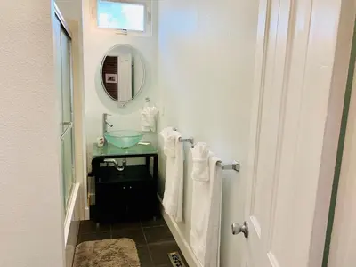 a bathroom with a sink and a mirror at The Cottage! Chic Bungalow near Old Town Square! in Fort Collins