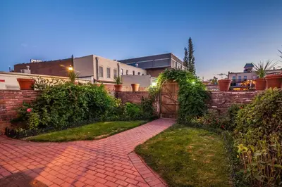 a brick driveway with a gate and a brick wall at Elegant Loft-Style Retreat in Old Firehouse Alley in Fort Collins