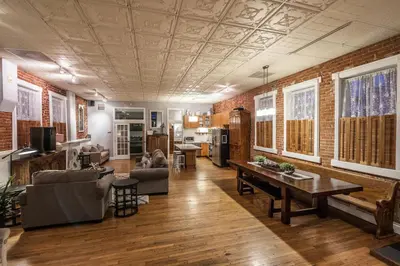a living room with a couch and a table at Elegant Loft-Style Retreat in Old Firehouse Alley in Fort Collins