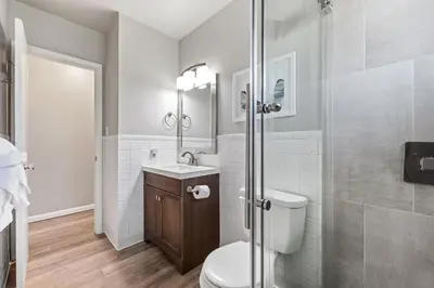 a bathroom with a toilet and a sink and a shower at Breathtaking Condo in the Heart of Old Town in Fort Collins