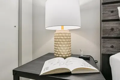 an open book on a table with a lamp at Breathtaking Condo in the Heart of Old Town in Fort Collins