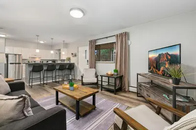 a living room with a couch and a table at Breathtaking Condo in the Heart of Old Town in Fort Collins
