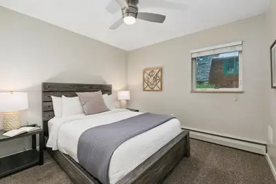 a bedroom with a bed and a window at Breathtaking Condo in the Heart of Old Town in Fort Collins