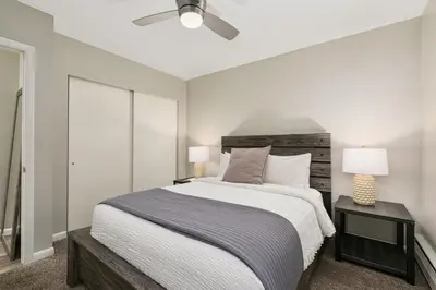 a bedroom with a large bed and a ceiling fan at Breathtaking Condo in the Heart of Old Town in Fort Collins
