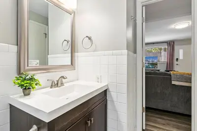 a bathroom with a sink and a mirror at Hip & Urban Condo near the Heart of Old Town in Fort Collins