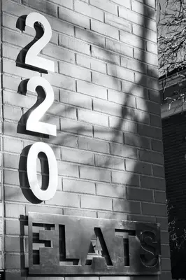 a sign on the side of a brick building at Hip & Urban Condo near the Heart of Old Town in Fort Collins