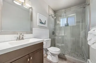 a bathroom with a shower and a toilet and a sink at Hip & Urban Condo near the Heart of Old Town in Fort Collins