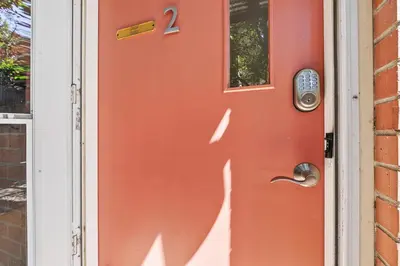 a red door with a number two on it at Hip & Urban Condo near the Heart of Old Town in Fort Collins