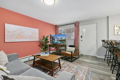 a living room with a couch and a table at Hip & Urban Condo near the Heart of Old Town in Fort Collins