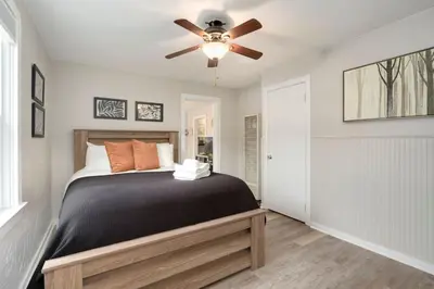 a bedroom with a bed with a ceiling fan at Charming Old Town Bungalow with Free Cruiser Bikes in Fort Collins