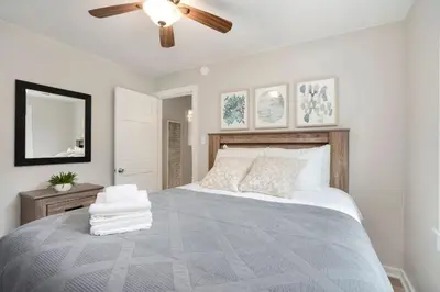 a bedroom with a bed with a ceiling fan at Charming Old Town Bungalow with Free Cruiser Bikes in Fort Collins
