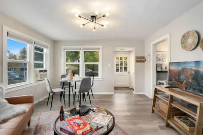 a living room with a couch and a table at Charming Old Town Bungalow with Free Cruiser Bikes in Fort Collins