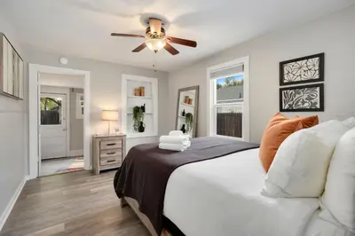 a bedroom with a bed and a ceiling fan at Charming Old Town Bungalow with Free Cruiser Bikes in Fort Collins
